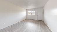Located at 2035 Kings Hwy in Clearwater, Florida, this single-floor, one-bedroom, two-bathroom home offers a thoughtfully laid-out interior with a clean, bright aesthetic throughout. The open living area features light-toned wood-style flooring, crisp white walls, and a textured ceiling that adds character to the space. Natural light filters in through multiple windows, enhancing the airy feel of the main living and dining areas. The dining room connects seamlessly to the kitchen, which is outfitted with warm wood cabinetry, a double-basin stainless steel sink, light countertops, and tile flooring — a functional space with a practical, welcoming design. The bedroom is carpeted for comfort and includes multiple closet spaces with louvered doors, along with a ceiling fan and windows that bring in natural light. A standout feature of the home is the bathroom, which boasts dramatic marble-style wall surrounds encasing a soaking tub, creating a striking visual focal point. With seven closets distributed throughout, storage is abundant. The layout flows naturally from the living spaces to the private bedroom areas, making the home feel organized and spacious for its footprint.