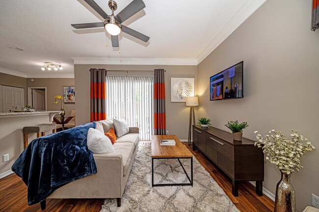 Spacious living room with hardwood-style flooring - The Indigo at Grissom