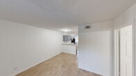 Located in Austin, TX, this 2-bedroom, 2-bathroom unit offers a practical and well-designed single-level layout. The open-concept living and kitchen area serves as the heart of the unit, where light wood-style flooring flows seamlessly underfoot and bright white walls create a clean, airy atmosphere. A ceiling fan with lighting anchors the living space, which also features a front-facing window fitted with blinds that allow natural light to filter in.

The kitchen is a standout feature, equipped with gray shaker-style cabinetry, a white quartz countertop with a built-in breakfast bar, a subway tile backsplash, a double stainless steel sink, and stainless steel appliances including a refrigerator and dishwasher. Track lighting above the kitchen adds functional illumination.

Both bedrooms continue the wood-style flooring and neutral color palette. The primary bedroom offers a comfortable footprint with a window providing natural light and access to a closet. The second bedroom is equally bright and versatile. Textured ceilings are consistent throughout the unit. With two full bathrooms, a dedicated closet, and a central Austin location, this unit provides a functional and modern living environment.
