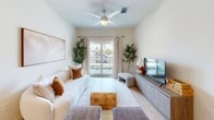 This contemporary 870 square foot apartment in Fort Myers, FL offers a thoughtful layout with 2 bedrooms and 3 bathrooms. The open-concept design creates a seamless flow between the living areas, enhancing the sense of space. The kitchen boasts sleek white cabinetry, granite countertops, and stainless steel appliances, complemented by a convenient island with seating.

The living room features a white sofa, artwork, and access to a balcony, flooding the space with natural light. Both bedrooms are well-appointed, with the primary bedroom spanning 150 square feet. The bathrooms are modern, with one showcasing a tub-shower combination and another a glass-enclosed shower.

A standout feature is the in-unit laundry room, equipped with a stacked washer and dryer and ample storage. Throughout the apartment, wood flooring adds warmth, while recessed lighting and ceiling fans enhance comfort. The neutral color palette and strategic placement of plants create a serene atmosphere, making this apartment a perfect blend of style and functionality.
