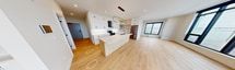 This contemporary apartment, located at 112 St James Street in London, offers a spacious 1550 square feet of living space on a single floor. The property features two bedrooms, including a generous primary bedroom of 250 square feet, and three bathrooms for added convenience.

The apartment's most striking feature is its abundance of natural light, courtesy of floor-to-ceiling windows that offer panoramic views of the surrounding cityscape. These expansive windows create a sense of openness and connection to the outside world, while also serving as a focal point in the living areas.

The open-plan design seamlessly integrates the kitchen, living, and dining areas, promoting a fluid and versatile living space. The kitchen is a highlight, boasting sleek white cabinetry, modern appliances, and a large central island, perfect for both meal preparation and casual dining.

Throughout the apartment, light-toned hardwood flooring complements the crisp white walls, creating a bright and airy atmosphere. The bathrooms feature contemporary fixtures, including a bathtub in at least one, with stylish tiling that adds a touch of luxury.

Storage is ample, with three closets distributed throughout the space. Two hallways provide easy navigation between rooms, ensuring a practical layout despite the open-plan design.

This apartment combines modern aesthetics with functional living, making it an ideal urban retreat in the heart of London.