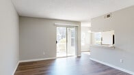 Located at 2352 Spring House Ln in Augusta, GA, this efficient one-bedroom, one-bathroom unit is thoughtfully laid out across a single floor, offering a practical and comfortable living arrangement. The open living room is a highlight of the space, featuring warm hardwood-style flooring, neutral gray walls, and a textured ceiling. A sliding glass door floods the room with natural light and provides direct access to an outdoor balcony with views of surrounding greenery, enhancing the sense of openness.

The galley-style kitchen is well-appointed with white cabinetry, light stone-look countertops, stainless steel appliances including a range and refrigerator, and a single-basin sink with a modern faucet. A flush-mount ceiling fixture provides ample illumination throughout.

The bedroom offers a cozy atmosphere with plush carpeting, neutral tones, and a large window that invites natural light. A closet provides convenient storage. An entrance hallway and additional storage spaces connect the rooms efficiently.

The bathroom is clean and functional, featuring a tub-shower combination, a white vanity with under-cabinet storage, a wall mirror, and hardwood-style flooring. A multi-bulb overhead light fixture completes the space. Overall, the unit presents a bright, well-maintained interior suited for comfortable everyday living.