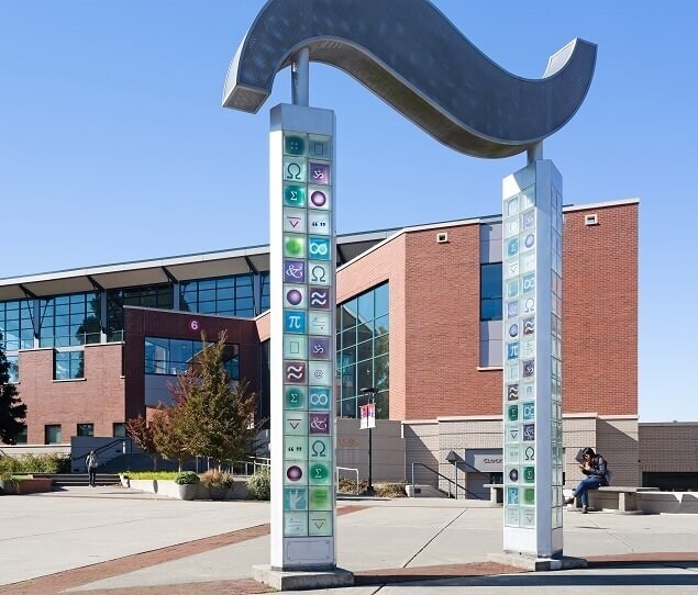 The Signs and Symbols archway lights up at night