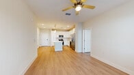 Located at 295 Royal Tern Circle in Rockledge, FL, this well-designed 2-bedroom, 2-bathroom single-floor residence offers a bright, open-concept layout with a clean, contemporary aesthetic. Light wood-look flooring runs consistently throughout the home, lending warmth and visual continuity to every room.

The heart of the home is the open kitchen and living area. The kitchen is outfitted with crisp white shaker-style cabinetry, white quartz countertops, a full suite of stainless steel appliances including a French door refrigerator, range, microwave, and dishwasher, and a center island ideal for meal prep or casual dining. Elegant pendant lighting hangs above the island, complementing the recessed lighting throughout. The kitchen flows seamlessly into the living area, which features a ceiling fan and access to natural light through windows and an exterior door.

Both bedrooms are generously proportioned, each with ceiling fans, large windows, and a calm neutral palette. The spacious primary bedroom connects to a private bathroom featuring a walk-in shower and direct access to a well-organized walk-in closet with built-in wire shelving. A second full bathroom serves the additional bedroom and guests. The home's efficient single-floor plan maximizes usability, offering comfortable living in a clean, modern setting.