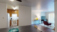 Located at 265 Camelback Rd in Pleasant Hill, CA, this single-floor residence offers a well-organized layout designed for comfortable everyday living. The open-concept living and dining area forms the heart of the home, where wood-style flooring flows continuously across the space. The dining area accommodates a full-sized table and is accented by a round wall mirror that adds depth to the room. A ceiling fan overhead provides practical comfort.

The living room is bright and inviting, highlighted by a large sliding glass door that opens to a private balcony, allowing generous natural light and outdoor views to fill the space. The kitchen is positioned adjacent to the dining area and features warm wood cabinetry, light stone-toned countertops, and a white electric range with overhead ventilation—offering a functional and efficient workspace.

Both bedrooms are carpeted and comfortably sized, each equipped with sliding-door closets providing ample storage. The two bathrooms echo consistent design elements, featuring wood-toned cabinetry with light countertops, wood-style flooring, and a shower-tub combination. One bathroom includes a compartmentalized layout with a separate water closet, enhancing privacy and usability. Overall, the space presents a clean, practical, and cohesive interior throughout.