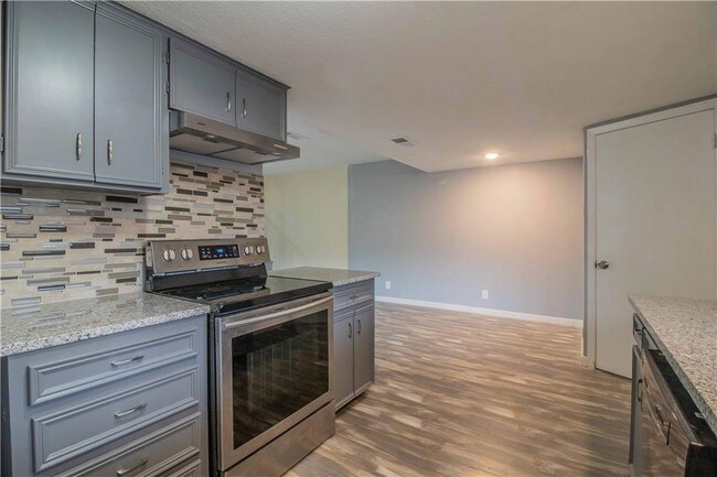 Kitchen with half bathroom behind the door - 2030 Fleur De Lis Ct