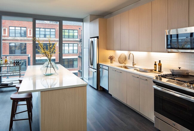 Elegant island kitchen with stainless-steel appliances - AMLI West Loop