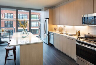 Elegant island kitchen with stainless-steel appliances - AMLI West Loop