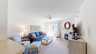 Located at 7545 Tree Ln in Madison, Wisconsin, this single-floor residence offers a well-designed layout with a comfortable and cohesive interior throughout. The living room serves as the heart of the home, featuring plush carpeting, a ceiling fan, a fireplace with a classic white mantel, and a large sliding glass door that fills the space with natural light and provides outdoor views. The kitchen is outfitted with ample white cabinetry accented with gold hardware, light countertops, full appliances including a built-in microwave, and tile flooring — offering both function and brightness. Adjacent to the kitchen, the dining area features warm carpeting and is anchored by an elegant chandelier, creating an inviting atmosphere for meals and gatherings. The bedrooms are generously sized with soft carpeting; one room includes dual closets and a window with natural light, making it versatile as a bedroom or home office. Both bathrooms are finished with tile flooring, white cabinetry, and wide vanity mirrors. A second full bathroom includes a shower-tub combination. Throughout the residence, a neutral warm palette and consistent finishes create a cohesive, calm ambiance suited to comfortable everyday living.