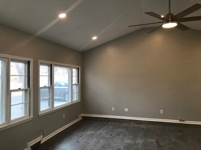 Vaulted ceiling in the den with ceiling fan. - 4012 park dr