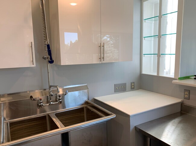 Kitchen with illuminated glass shelves. - 1725 NE Wheatland Dr