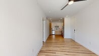 Located at 701 Saginaw Blvd in Saginaw, TX, this thoughtfully designed one-bedroom, one-bathroom residence offers a clean, modern aesthetic throughout its single-story layout. Light wood-look plank flooring flows seamlessly across every room, lending warmth and visual continuity to the entire space.

The open-concept living and kitchen area serves as the heart of the unit. The kitchen is well-appointed with a two-tone cabinetry scheme — white upper cabinets paired with natural wood-finish lower cabinets — complemented by a shimmering tile backsplash, white countertops, and a full suite of stainless steel appliances, including a refrigerator, electric range, over-the-range microwave, and dishwasher. Recessed lighting illuminates the kitchen, while a ceiling fan overhead keeps the living area comfortable.

The bedroom is a bright, calm retreat featuring a large window that invites natural light and offers outdoor views. A ceiling fan adds to the comfort of the room, which connects directly to the bathroom and a walk-in closet outfitted with built-in shelving and hanging rods.

The bathroom features wood-toned cabinetry with a white countertop vanity. An in-unit laundry area and a private patio round out the functional amenities, making this a well-equipped and efficient living space.