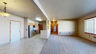 Located in Spokane Valley, WA, this single-floor, 3-bedroom, 2-bathroom residence offers a practical and comfortable layout designed for everyday living. The open-concept kitchen and living area form the heart of the home, with tile flooring in the kitchen transitioning to plush carpet in the living space. The kitchen features warm wood cabinetry, a tile backsplash, stainless steel appliances including a refrigerator and range, a built-in microwave, and a dishwasher, all arranged in an efficient galley-style layout. A peninsula counter connects the kitchen to the living area, enhancing the open flow of the space. A hallway leads to the three bedrooms, each finished with soft carpet and fitted with window blinds that allow natural light. The generously sized primary bedroom includes a walk-in closet outfitted with wire shelving and hanging rods for ample storage. The bathrooms feature tile flooring, wood-toned vanity cabinetry, and a full soaking tub. A dedicated laundry room houses a full-size washer and dryer with overhead wire shelving. The attached garage provides additional utility and secure parking, rounding out this well-appointed residence.