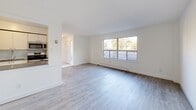 Located at 7555 Goreway Drive in Mississauga, Ontario, this two-storey residence offers a well-organized layout across two floors, with the main level providing communal living spaces and the upper level dedicated to private quarters. The ground floor features an open living area with light-toned laminate wood flooring that extends throughout, a large picture window that fills the space with natural light, and a connected kitchen equipped with appliances including a microwave and stove. A tiled entryway welcomes you at the front door, leading seamlessly into the main living area. The upper floor hosts three bedrooms, including a generously sized primary bedroom, each outfitted with sliding closet doors — one set finished with mirrored panels for a spacious feel. Bedrooms benefit from large windows and sliding glass doors that open to outdoor views of the surrounding greenery and neighbourhood. The bathroom is finished with marble-style tile flooring, a white vanity with cabinetry, and a tiled shower-tub combination, maintaining a clean and bright aesthetic. Multiple hallways connect the layout efficiently across both floors. A utility room and additional unclassified spaces offer practical storage and functional flexibility. The overall interior presents a clean, neutral palette throughout.