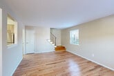 This two-story home in Prospect Park, PA offers a well-organized layout spread across two floors. The main level welcomes you with warm hardwood flooring throughout the open living and dining areas, bathed in natural light from street-facing windows. A wall-unit HVAC system ensures year-round comfort. The kitchen is efficiently designed with light wood cabinetry, a white tile backsplash, stainless steel appliances including a refrigerator, electric range, microwave, and dishwasher, and durable tile flooring. A staircase with a sleek metal railing connects the two levels. Upstairs, two bedrooms offer plush carpeting and ample natural light from multiple windows. The generously sized primary bedroom features two windows with outdoor views of the surrounding neighborhood. Four closets throughout the home provide generous storage. The full bathroom is finished with stone-look tile flooring, a tub-shower combination with marble-style tile surround, and brushed nickel fixtures. A dedicated bathroom with laundry accommodates a full-size washer and dryer, adding everyday convenience. Neutral wall tones and clean white trim create a cohesive, move-in-ready aesthetic throughout.