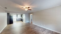 Located in Lexington Heights, this single-floor home offers a clean, functional layout designed for comfortable everyday living. The spacious living area features warm wood-look flooring, neutral-toned walls with crown molding, and a ceiling fan with light fixture, creating a bright and airy atmosphere. The open flow between the living area and kitchen makes the space feel connected and inviting.

The kitchen is well-appointed with rich dark gray cabinetry offering ample upper and lower storage, light countertops, a double sink with a window above it bringing in natural light, and black appliances including a refrigerator, electric range, and dishwasher. A textured ceiling and flush-mount lighting complete the kitchen's practical design.

The bedrooms continue the wood-look flooring and feature crown molding, neutral walls, and built-in closets, offering a tidy and versatile space. The bathroom is finished with tile-surround tub and shower, wood-look flooring, and a vanity with a light countertop, presenting a clean and classic aesthetic.

Throughout the home, consistent flooring, neutral color palettes, and well-maintained finishes create a cohesive and move-in-ready environment that is both practical and comfortable.