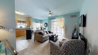 Located at 1500 Horizon in Manchester, Connecticut, this single-floor residence offers a thoughtfully designed open-concept layout that seamlessly connects the main living spaces. The living room is highlighted by soft teal accent walls, plush carpeting, and a sliding glass door that opens to a private balcony, filling the space with natural light and outdoor views. A ceiling fan adds to the comfort of the room. Adjacent to the living area, the dining space features large windows dressed with sheer curtains, creating a bright and inviting atmosphere. The kitchen is well-equipped with warm maple cabinetry, dark granite-style countertops, a full suite of stainless steel appliances, a tiled backsplash, and a versatile freestanding island, all set on clean tile flooring. The primary bedroom offers a serene retreat with a teal accent wall and soft carpeting, with direct access to a private en-suite bathroom featuring a dual-sink vanity and tile flooring. The second bedroom is comfortably sized with its own closet. A second full bathroom includes a soaking tub, shower combination, and a single-sink vanity. Throughout the residence, a cohesive color palette and consistent finishes create a polished, comfortable living environment.