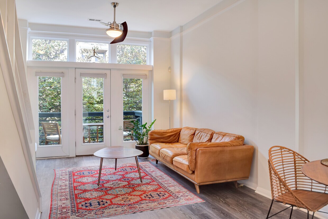 Bright living room with balcony overlooking rail trail - 324 New Bern Station Ct