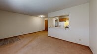 Located at 2360 Wrens Dr N in Stow, Ohio, this single-floor unit offers a practical and comfortable layout across a compact, well-organized floor plan. The combined kitchen and living room forms the heart of the unit, with an open pass-through design connecting the two spaces. The living area features neutral-toned carpet, light-colored walls, and a textured ceiling, creating a clean and welcoming atmosphere. The kitchen is well-equipped with warm oak cabinetry, light countertops in an L-shaped configuration, a double stainless steel sink, a dishwasher, a refrigerator, and a stove, all complemented by durable wood-look flooring. A pass-through window between the kitchen and living area enhances the open feel and allows for easy interaction between spaces. The bedroom is a generous, well-proportioned room featuring plush carpeting, neutral walls, a textured ceiling, and a large window that allows natural light and outdoor views to fill the space. A sliding wood-panel closet provides ample storage. A hallway connects the main living areas, providing a logical and efficient flow throughout the unit. Overall, the space presents a clean, functional, and straightforward design suited for comfortable everyday living.