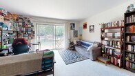 Located at 1319 N Jackson St in Milwaukee, WI, this efficiently designed single-floor unit offers a well-organized layout comprising a living room, kitchen, and full bathroom. The living room serves as the heart of the space, featuring plush carpeting, light-toned walls, and a large sliding glass door that opens to a private balcony overlooking a tree-lined outdoor area. Natural light pours in generously through the expansive glass door, creating an airy and welcoming atmosphere. The room provides ample space for comfortable seating arrangements and personal expression. The kitchen is thoughtfully laid out with warm wood-toned cabinetry, light granite-style countertops, tile flooring, and a full suite of white appliances including a range, over-the-range microwave, and refrigerator. A sink positioned beneath upper cabinets maximizes storage and functionality within the compact footprint. The bathroom is clean and straightforward, finished with tile flooring and a shower-tub combination. Its neutral palette keeps the space feeling fresh and practical. Overall, this unit offers a cozy, functional living environment well-suited for those seeking a convenient location on Milwaukee's lively East Side.