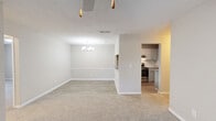 Located at 100 Arbor Circle in Tucker, Georgia, this single-floor, three-bedroom residence offers a well-organized and functional layout with a neutral color palette and plush carpeting throughout. The open living room is a welcoming focal point, anchored by a brick-surround fireplace and a ceiling fan overhead. Sliding glass doors lead to an outdoor deck, flooding the space with natural light and providing pleasant outdoor views. An adjoining dining area with a chandelier connects seamlessly to the kitchen, which features gray cabinetry, a white subway tile backsplash, stainless steel appliances, and wood-look flooring — offering both style and practicality. The spacious primary bedroom provides ample room to relax, while two additional bedrooms, each carpeted and well-lit, offer versatility for guests, a home office, or other uses. One bedroom includes both a window and direct outdoor door access, enhancing its appeal. A central hallway connects the bedrooms, and a dedicated laundry room houses a full-size Whirlpool washer and dryer. A closet provides additional storage. The textured ceilings and consistent neutral tones throughout give the space a cohesive, move-in-ready feel.