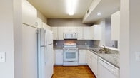 This single-floor, one-bedroom, one-bathroom unit in Memphis, TN offers a well-organized layout with a cohesive, neutral design throughout. The living area is a comfortable, open space featuring rich hardwood-style flooring, crown molding, a ceiling fan, and a classic white fireplace that serves as a focal point. Multiple windows allow natural light to flow in, creating a bright and inviting atmosphere.

Adjacent to the living area, a dedicated dining space also features hardwood-style flooring and large windows overlooking the outdoors. The kitchen is efficiently designed in a U-shaped configuration, outfitted with white cabinetry extending to the ceiling for ample storage, granite-style countertops, a full suite of white appliances including a refrigerator, electric range, microwave, and dishwasher, and a stainless steel sink. A pass-through connects the kitchen to the main living area.

The bedroom is carpeted for comfort, includes a ceiling fan, a window for natural light, and access to a closet. The bathroom is practical and well-appointed, with hardwood-style flooring and convenient access to in-unit stacked laundry. Overall, the unit presents a clean, functional living environment.