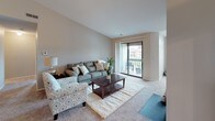 Located at 5147 Lancaster Hills Dr in Clarkston, Michigan, this single-floor residence offers a well-organized layout designed for comfortable everyday living. The living room is bright and welcoming, featuring plush carpeting, neutral tones, and a large sliding glass door that opens to a private balcony, providing an abundance of natural light and outdoor access. Adjacent to the living room, the dining area is defined by vaulted-style walls and a chandelier overhead, creating an intimate setting ideal for gatherings. The galley-style kitchen is efficiently designed with light wood cabinetry, ample counter space, wood-look flooring, and includes essential appliances such as a refrigerator, electric range, and dishwasher. The primary bedroom features large windows with outdoor views, soft carpeting, and direct access to a walk-in closet. A second bedroom is equally well-lit, benefiting from dual windows that frame views of the surrounding greenery. Two full bathrooms serve the residence, each featuring wood-look flooring, a vanity with storage, and a shower-tub combination. Additional closet space is found throughout, enhancing the overall storage capacity of the home. The neutral color palette and consistent finishes give the space a cohesive and move-in ready feel.