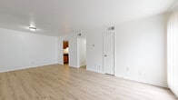 This 2-bedroom, 2-bathroom single-story unit is thoughtfully laid out to maximize functionality and comfort. Light wood-tone vinyl flooring runs consistently throughout the space, lending a clean and cohesive aesthetic to every room.

The living room is a bright, open area with crisp white walls and large sliding glass doors fitted with vertical blinds, allowing ample natural light and outdoor views. The kitchen is efficiently designed with warm oak cabinetry, granite-look countertops, and stainless steel appliances including a range and full-size refrigerator, complemented by an overhead exhaust hood.

The primary bedroom is generously sized and features a large sliding glass window with vertical blinds that invite natural light, along with dedicated closet space. The second bedroom is well-proportioned with its own closet and overhead lighting. Both rooms share the same consistent light flooring found throughout the unit.

Each of the two bathrooms is clean and functional, featuring white vanity cabinetry topped with granite-look countertops, a framed mirror, and a shower-tub combination. The hallway connects all rooms efficiently, providing a logical flow through the unit. Two closets offer additional storage to support everyday living needs.