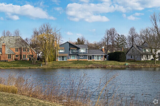 A row of homes in Lake Forest all share a fantastic view with a pond.