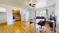 Located at 1075 Myrtle St in Los Alamos, New Mexico, this one-bedroom, one-bathroom home offers a practical and efficient single-floor layout. Warm hardwood flooring runs throughout the main living areas, lending a bright and inviting character to the space. The open living room features a ceiling fan with light fixture and a large window that allows natural light to flow in while offering views of the surrounding neighborhood. The kitchen is positioned adjacent to the living area and is equipped with wood cabinetry, a gas range, stainless steel sink, tile backsplash, and overhead microwave, providing all essential cooking amenities in a compact footprint. The bedroom is carpeted for comfort, includes a ceiling fan, a closet, and a window that brings in additional natural light. Two closets offer practical storage solutions throughout the unit. The bathroom is straightforward and functional, featuring a stand-up shower and toilet with built-in cabinet storage. Throughout the home, clean white walls and ceiling fans in each room contribute to a simple, well-maintained aesthetic well-suited for efficient everyday living in the heart of Los Alamos.