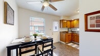 Located at 1250 Kelburn Rd in Columbus, Ohio, this two-floor home offers a practical and comfortable layout suited for everyday living. The main level features a combined kitchen and dining area, where warm oak cabinetry, dark granite-style countertops, and tile flooring create a functional cooking space. A ceiling fan overhead and windows admitting natural light make the dining area bright and welcoming, with room for a full dining set. Adjacent to the kitchen is a dedicated dining nook with carpeted flooring and additional ceiling fan.

The living area on the lower level is carpeted and open, centered around a staircase with classic dark metal balusters that leads to the upper floor. The space is understated and versatile, offering ample room for seating arrangements. Upstairs, the primary bedroom features hardwood flooring, dual windows, and a ceiling fan, while a secondary bedroom offers a quieter, naturally lit retreat with neighborhood views. A full bathroom with a tub-shower combination, tile flooring, and a windowed wall serves the upper level. A dedicated laundry room with overhead cabinetry and washer/dryer hookups adds convenience. Throughout, neutral wall tones and clean finishes give the home a cohesive, move-in-ready character.