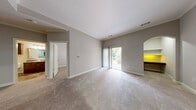 This 710 square foot apartment at Lodge At Ames Pond offers a well-designed living space with attention to detail. The kitchen showcases modern appliances, including a black refrigerator, and wooden cabinetry complemented by granite countertops. The unique multi-colored slate flooring adds character to both the kitchen and laundry areas.

The living spaces are generously proportioned, featuring neutral-toned carpeting and walls, creating a bright and airy atmosphere. Large windows and a sliding glass door leading to the balcony allow natural light to flood the rooms. A stand-out feature is the built-in desk nook with yellow accent lighting, perfect for a home office setup.

The primary bedroom, measuring 140 square feet, includes a ceiling fan and a walk-in closet with ample shelving. The second bedroom also offers good proportions and storage solutions. Both living areas provide flexible spaces for relaxation or entertainment.

The apartment's layout incorporates arched doorways, adding an elegant touch to the overall design. Crown molding and baseboards throughout contribute to a polished look. The in-unit laundry room with full-sized appliances offers convenience, while multiple closets throughout ensure plenty of storage options.

This thoughtfully designed apartment combines functionality with style, creating a comfortable and inviting living environment.