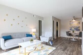 Located at 2515 Northeast Expy NE in Atlanta, GA, this single-floor residence offers a well-organized layout with a cohesive, contemporary design throughout. The living room serves as the heart of the home, featuring wood-style flooring, neutral gray walls, and a sliding glass door that opens to a private balcony, allowing natural light to flow freely into the space. Adjacent to the living area, the dining room is appointed with a ceiling fan, wood-style flooring, and direct sight lines into the kitchen, creating a seamless open feel ideal for everyday living and entertaining. The kitchen is outfitted with dark espresso cabinetry, light stone countertops, a subway tile backsplash, and black appliances, including a gas range and refrigerator. The bedrooms are carpeted and generously proportioned, each offering neutral tones, natural light from well-placed windows, and ample room for furnishings. The bathrooms continue the refined aesthetic with dark vanity cabinetry, light stone countertops, framed mirrors, subway tile wainscoting, and wood-style tile flooring. Throughout the residence, a consistent palette of soft grays and warm wood tones creates a calm, cohesive ambiance suited for comfortable everyday living in Northeast Atlanta.