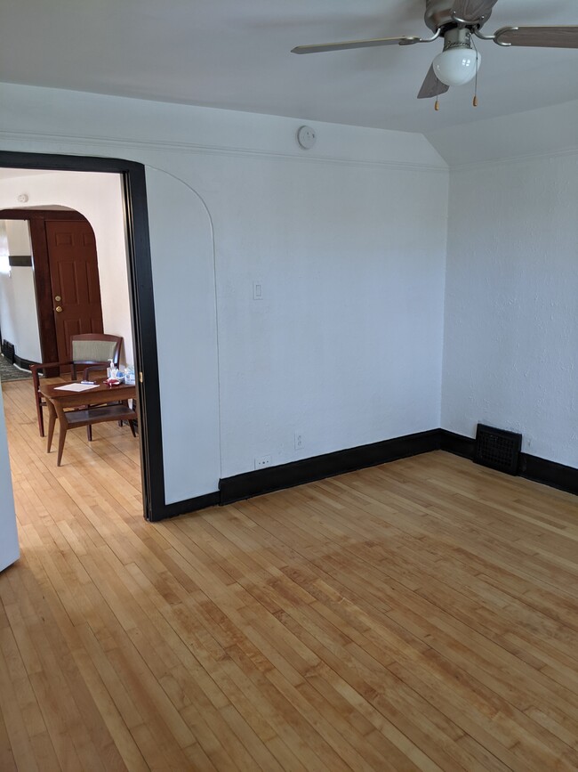 Front room looking through living room towards entryway. Could easily be used as a large third bedro - 3291 S 3rd St