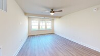 Located at 7006 Brookfield Rd in Columbia, SC, this single-story home offers a practical and well-organized layout across three bedrooms and two full bathrooms. The interior is finished with a clean, neutral color palette and a mix of light hardwood-style flooring and plush carpeting, creating a comfortable and cohesive aesthetic throughout.

The kitchen is equipped with stainless steel appliances, including a Whirlpool range, over-the-range microwave, dishwasher, and refrigerator. Rich brown cabinetry with ample storage pairs with light stone-look countertops, and the space flows seamlessly onto hardwood-style flooring for easy maintenance.

The living room is bright and airy, featuring a ceiling fan with a light kit and a trio of windows that invite natural light and provide views of the surrounding yard. The primary bedroom is generously sized, also showcasing multiple windows and hardwood-style flooring. The additional bedrooms are carpeted, each with natural light access; one includes a ceiling fan and a double-door closet.

Both bathrooms are finished in clean white tones with tub-shower combinations, dark wood vanities, and light flooring. A well-connected hallway links all rooms efficiently, making this home functional and easy to navigate.