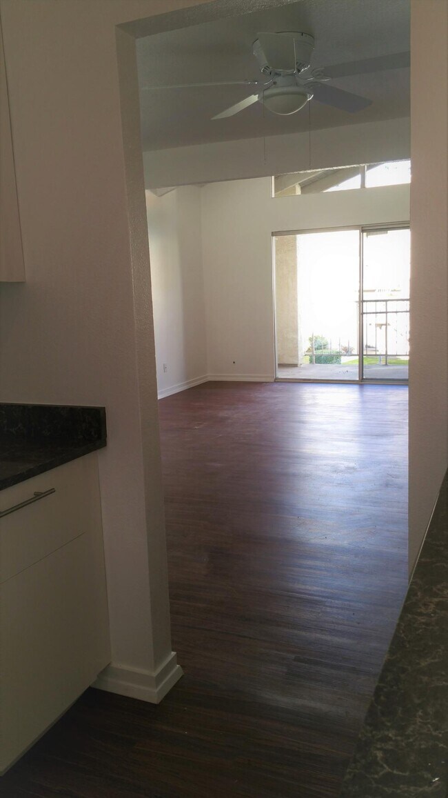 Kitchen looks out toward Dining Area with ceiling fan, Living Room and Balcony. - 35152 Mesa Grande Dr