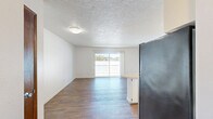 Located at 900 NE Minnehaha St in Vancouver, WA, this one-bedroom, one-bathroom unit offers a well-organized single-floor layout with a clean, bright aesthetic throughout. Warm hardwood-style flooring runs consistently across all rooms, lending a cohesive and inviting feel to the space.

The open-concept kitchen and living area form the heart of the unit. The kitchen features an L-shaped layout with a peninsula counter that extends into the living area, providing additional prep space and a natural divider between the two zones. White cabinetry lines the upper and lower walls, offering generous storage, while stainless steel appliances — including a range, dishwasher, and refrigerator — add a modern touch. A textured ceiling with flush-mount lighting keeps the space feeling bright and functional.

The living area benefits from access to a private balcony through a sliding glass door fitted with vertical blinds, allowing for natural light and a pleasant outdoor view of the surrounding neighborhood.

The bedroom is a comfortable, well-proportioned room with a wide window that frames views of the exterior greenery and brings in natural light. White walls and the same hardwood-style flooring create a calm, neutral environment.

The bathroom includes a full-size soaking tub and shower combination with chrome fixtures, a single-sink vanity with countertop storage, and hardwood-style flooring that maintains the consistent design language found throughout the unit.