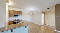 This well-appointed one-bedroom, one-bathroom apartment at 2000 Villa Dr in Pittsburg, CA offers a comfortable and functional layout across a single floor. The open-concept kitchen and living area forms the heart of the home, with tile flooring in the kitchen transitioning to plush carpet in the living space. The kitchen is equipped with stainless steel appliances — including a refrigerator, dishwasher, microwave, and range — complemented by warm wood cabinetry, granite-style countertops, and a breakfast bar ideal for casual dining. The living room features a ceiling fan with light fixture, neutral warm-toned walls, and access to a private outdoor area through a glass-paneled door, allowing for natural light and outdoor views. The spacious bedroom includes a ceiling fan, tray ceiling detail, and direct access to a generously sized walk-in closet outfitted with multi-level wire shelving and hanging rods. The bathroom offers a full tub/shower combo, a vanity with wood cabinetry and overhead storage, tile flooring, and a large mirror. Throughout the unit, neutral tones and consistent finishes create a cohesive and inviting ambiance.