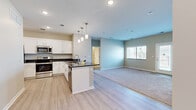 Located at 2494 Flat Top Ln in Grand Junction, Colorado, this single-story, 3-bedroom, 2-bathroom home offers a well-designed layout with modern finishes throughout. The open-concept kitchen and living area serves as the heart of the home, featuring white shaker-style cabinetry, dark granite countertops, a kitchen island with pendant lighting, stainless steel appliances, and light wood-look flooring. The adjacent living room is generously sized with carpet flooring, neutral-toned walls, and a door providing direct outdoor access with natural light from a front-facing window. The primary bedroom is a comfortable retreat with plush carpet, a ceiling fan, and multiple windows that bring in natural light. Additional bedrooms share similarly neutral tones, carpet flooring, ceiling fans, and closets with built-in shelving. Both bathrooms are finished with white cabinetry, dark granite countertops, and light wood-look flooring. The full bathroom includes a shower-tub combo, while the primary bath features access to a walk-in closet. Recessed lighting and consistent neutral color palettes create a clean, cohesive aesthetic throughout the entire home.