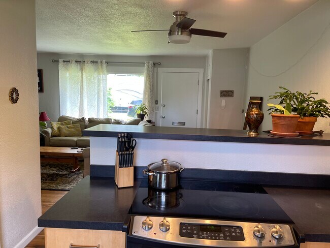 Open kitchen to main room with half bar/stove - 806 June St.