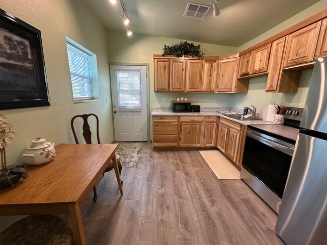 Kitchen, front door opens into spacious new kitchen cabinets and appliances - 400 Main St
