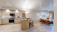 Located at 2777 West Sandalwood Drive in Lehi, Utah, this thoughtfully designed one-bedroom, one-bathroom residence offers a comfortable and stylish single-floor layout. Light wood-tone flooring flows throughout, tying together a cohesive, modern aesthetic.

The open-concept kitchen and living area serves as the heart of the home. The kitchen features flat-front cabinetry in a warm natural wood finish, stone-look countertops, a tile backsplash, stainless steel appliances, and generous pendant lighting over the peninsula. The living room is bright and welcoming, with track lighting, neutral walls, and a sliding glass door that opens onto a private balcony with exterior views.

The bedroom is a serene retreat, complete with a large window, natural light, and a sliding barn door that leads to a spacious walk-in closet. The closet is outfitted with built-in shelving and wire hanging rods, providing ample organization. The bathroom offers a clean, spa-like feel with a light wood vanity, stone countertop, an illuminated frameless mirror, and wood-look flooring. A hallway connects the rooms, and an in-unit washer/dryer is also included. The overall ambiance is calm, contemporary, and efficiently designed.