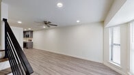 This well-appointed two-story home in Gonzales, Louisiana offers a thoughtfully designed layout with two bedrooms, two full bathrooms, and a convenient half bath. The main level features an open living area with light wood-look vinyl plank flooring, recessed lighting, and a ceiling fan, creating a bright and comfortable gathering space that flows seamlessly into the kitchen. The kitchen is a standout feature, showcasing gray shaker-style cabinetry, crisp white quartz countertops, a stainless steel undermount sink, and a full suite of stainless steel appliances including a range, microwave, and dishwasher. Upstairs, both bedrooms are generously sized, each with wood-look flooring, ceiling fans, and windows with blinds that allow for natural light. Each bedroom benefits from its own private en-suite bathroom, with consistent gray vanity cabinetry and white countertops that match the home's modern aesthetic. The bathrooms are clean and functional, finished with neutral tile flooring. A half bath serves guests on the main level. Throughout the home, clean white walls, panel-style doors, and cohesive finishes contribute to a fresh, contemporary ambiance ideal for comfortable everyday living.