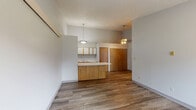 Located at 2315 Muirwood Dr in Columbus, Ohio, this single-floor, one-bedroom, one-bathroom unit offers a practical and efficient layout. The open living and dining area features durable wood-look vinyl flooring, neutral gray walls, and a textured ceiling, creating a clean and versatile space. A pendant light fixture adds a subtle decorative touch, while a set of double doors provides convenient storage.

The kitchen is designed for functionality, featuring white cabinetry with wood-trim accents, a double-basin stainless steel sink, ample upper and lower cabinet storage, a white electric range, and a full-size refrigerator. The wood-look flooring continues throughout, maintaining a cohesive aesthetic.

The bedroom is carpeted for comfort and includes a ceiling fan with a light fixture, a window that allows natural light, and a wall-mounted heating unit. The neutral tones and soft carpet make the room a calm and restful retreat.

The bathroom is straightforward and well-appointed, featuring a full-size soaking tub with an overhead shower, white tile surround, and wood-look flooring that ties in with the rest of the unit. Overall, the space offers a no-frills, functional living environment well-suited for everyday comfort.