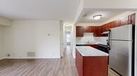 This contemporary 2-bedroom, 1-bathroom apartment in Norwood, MA offers 710 square feet of thoughtfully designed living space. The open-concept layout combines the kitchen and living room, creating a spacious and inviting atmosphere. The kitchen boasts rich wood cabinetry, stainless steel appliances, and sleek countertops, perfect for culinary enthusiasts. Large windows throughout flood the space with natural light, enhancing the airy feel of the neutral-toned interiors. The primary bedroom, measuring 190 square feet, provides ample space for relaxation. Both bedrooms feature built-in closets for convenient storage. The bathroom showcases clean, white fixtures and tiling. Durable wood-look flooring runs throughout the apartment, adding warmth and easy maintenance. A sliding glass door in the living area leads to an outdoor space, extending the living area and offering views of the surrounding greenery. This well-appointed apartment combines modern amenities with practical design, creating a comfortable and stylish home.