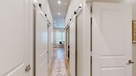 This well-designed one-bedroom, one-bathroom unit in Conroe, Texas offers a thoughtfully organized single-floor layout that maximizes every square foot. Light wood-look flooring flows throughout, creating a cohesive and airy feel across all rooms.

The open-concept living area is bright and welcoming, featuring a ceiling fan, large windows with sheer curtains that invite natural light, and ample room for both a seating area and a dining space. The kitchen is outfitted with gray shaker-style cabinetry, white quartz countertops, a subway tile backsplash, and a full suite of stainless steel appliances including a refrigerator with ice maker, range, microwave, and dishwasher.

A standout feature of this unit is the hallway lined with stylish sliding barn doors, providing access to multiple closets — an impressive storage solution that adds both character and practicality. The bedroom is comfortably sized, offering a ceiling fan, a calm neutral palette, and direct access to a walk-in closet also fitted with a barn door.

The bathroom is clean and modern, featuring gray vanity cabinetry with a white countertop, a glass-enclosed walk-in shower with built-in tile niche, and wood-look tile flooring. A dedicated laundry area completes this efficient and attractive home.