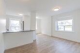 This 450 square foot apartment in Toronto offers a thoughtful layout maximizing space and functionality. The single-floor unit comprises one bedroom, one bathroom, a kitchen, and a hallway. The primary bedroom, measuring 110 square feet, provides ample space for rest and relaxation.

The kitchen showcases a modern design with white cabinetry, subway tile backsplash, and stainless steel appliances, including a built-in microwave. A peninsula counter offers additional workspace and casual dining options. Light-toned hardwood flooring extends throughout the living areas, creating a sense of continuity and openness.

The bathroom features a contemporary aesthetic with large-format white subway tiles adorning the walls and hexagonal tiles on the floor. A glass-enclosed shower with a modern fixture enhances the space's sleek appearance.

Large windows in both the bedroom and living area flood the apartment with natural light, while offering views of the surrounding neighborhood. The crisp white walls and ceiling contribute to the bright, airy atmosphere.

Located at 2837 Yonge St, Toronto, this apartment combines efficient design with modern amenities, making it an ideal urban dwelling for those seeking a compact yet stylish living space in a prime location.