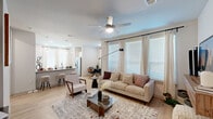 Located in Spring, TX, this single-story 2-bedroom, 2-bathroom home offers a thoughtfully designed open-concept layout with modern finishes throughout. The combined living and dining area is bright and welcoming, featuring light wood-look flooring, large windows dressed with elegant curtains, and ceiling fans that enhance comfort. The living space flows seamlessly into a dedicated dining area and an open work nook, making the layout both functional and versatile.

The kitchen is a standout feature, boasting white shaker cabinetry, granite countertops, a tile backsplash, stainless steel appliances, a built-in island with bar seating, and pendant lighting — all complemented by abundant natural light from nearby windows.

Both bedrooms are carpeted and offer ceiling fans, large windows, and generous closet space. The primary bedroom provides a comfortable and well-proportioned retreat. The two bathrooms are finished in crisp white tile with granite vanity tops, one featuring a full soaking tub with shower. A dedicated in-unit laundry room with full-size washer and dryer hookups adds everyday convenience. The overall aesthetic is clean, contemporary, and move-in ready.