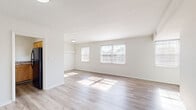 Located at 1250 Beaumont Ave in Baltimore, MD, this single-floor, 3-bedroom, 1-bathroom home offers a clean, updated interior with a bright and welcoming atmosphere. The living room is a standout space, featuring light-toned wood-look flooring, crisp white walls, and multiple windows that flood the room with natural light, creating an airy and open feel. The generous primary bedroom continues the wood-look flooring and is bathed in natural light from dual windows with views of the neighborhood. The additional bedrooms are carpeted for comfort, each featuring windows with blinds and closet storage, including a closet with a rod and shelf for organization. The kitchen is appointed with light wood cabinetry, stone-patterned laminate countertops, and a stainless steel sink. A unique interior storage or utility space features a white-painted brick accent wall and wood-look flooring, adding character to the home. The bathroom is clean and functional, offering wood-look flooring, white subway tile surround, a soaking tub, and a toilet. A connecting hallway ties all rooms together efficiently. The home's neutral palette and updated finishes create a move-in-ready space with a fresh, modern feel.