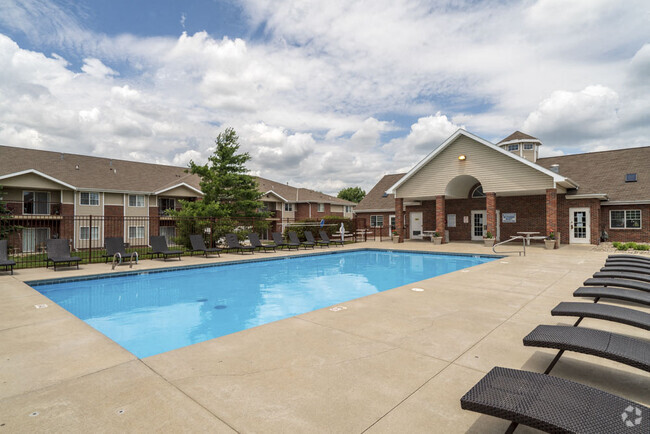 Our community features a sparkling pool and plenty of lounge seating, offering the perfect place to relax and enjoy sunny days. - Northbrook Apartments